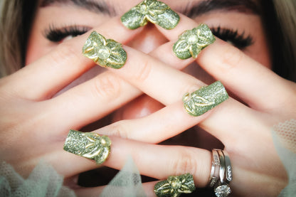 Green Blossom press-on nails with green glitter with raised gold-outlined clear flowers.