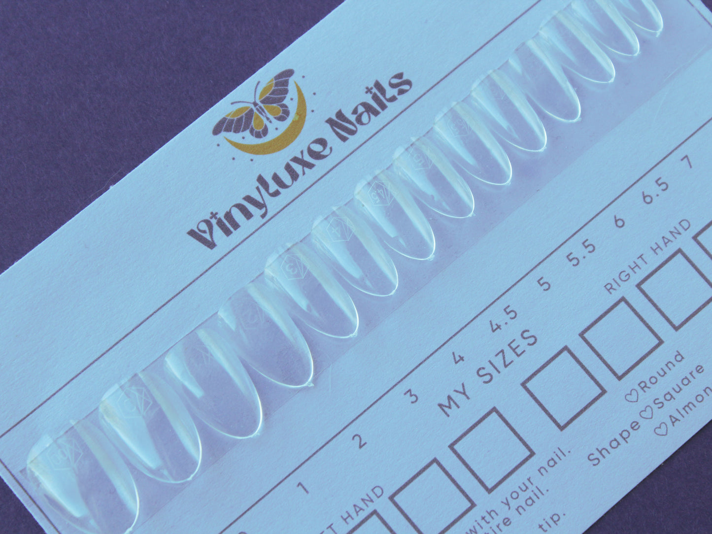 Press-on nail sizing kit with clear nail tips in multiple sizes on sizing card